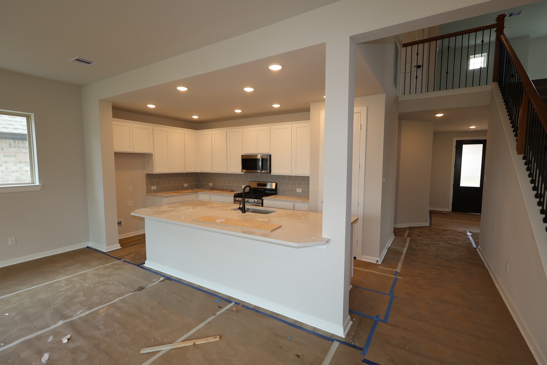 42568 Edmund Rucker Lane Magnolia, TX 77354 - Photo 8 of 18 a view of open kitchen with kitchen island granite countertop a refrigerator and a sink
