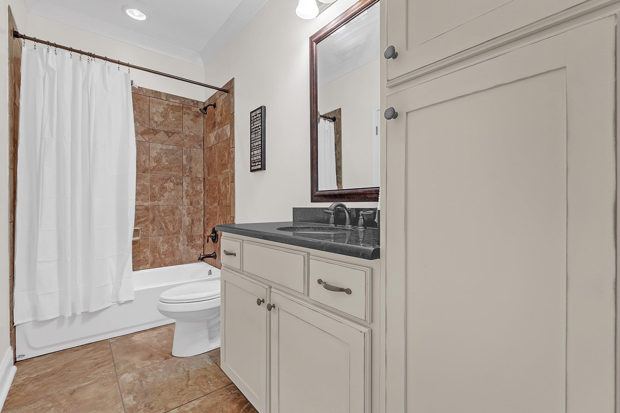 3246 North Hartwell Ridge Drive Collierville, TN 38017 - Photo 34 of 40 Bathroom featuring a white vanity with dark countertop, large mirror, and built-in storage