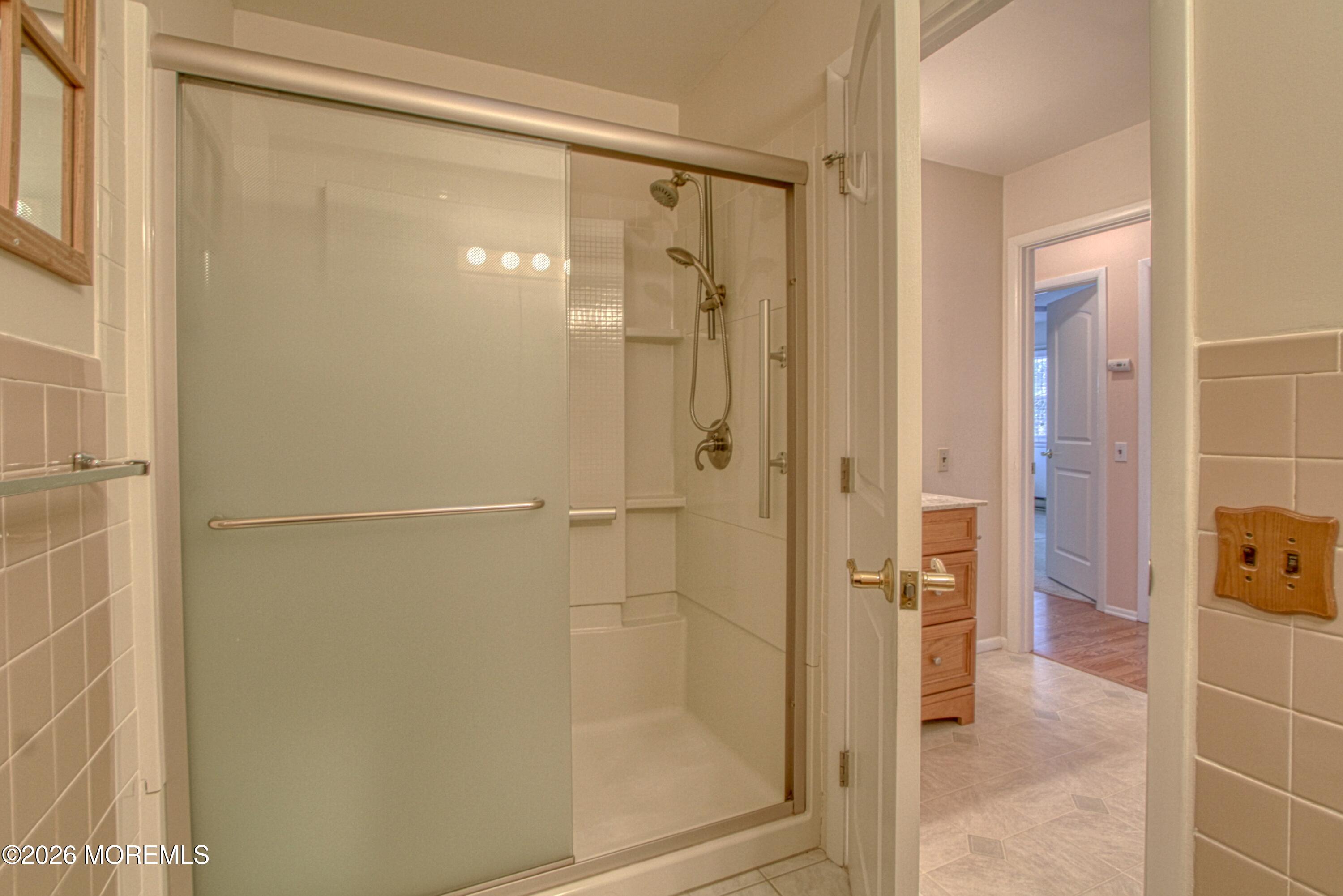 12 Homestead Drive, Unit A Whiting, NJ 08759 - Photo 11 of 18 a bathroom with a glass shower door