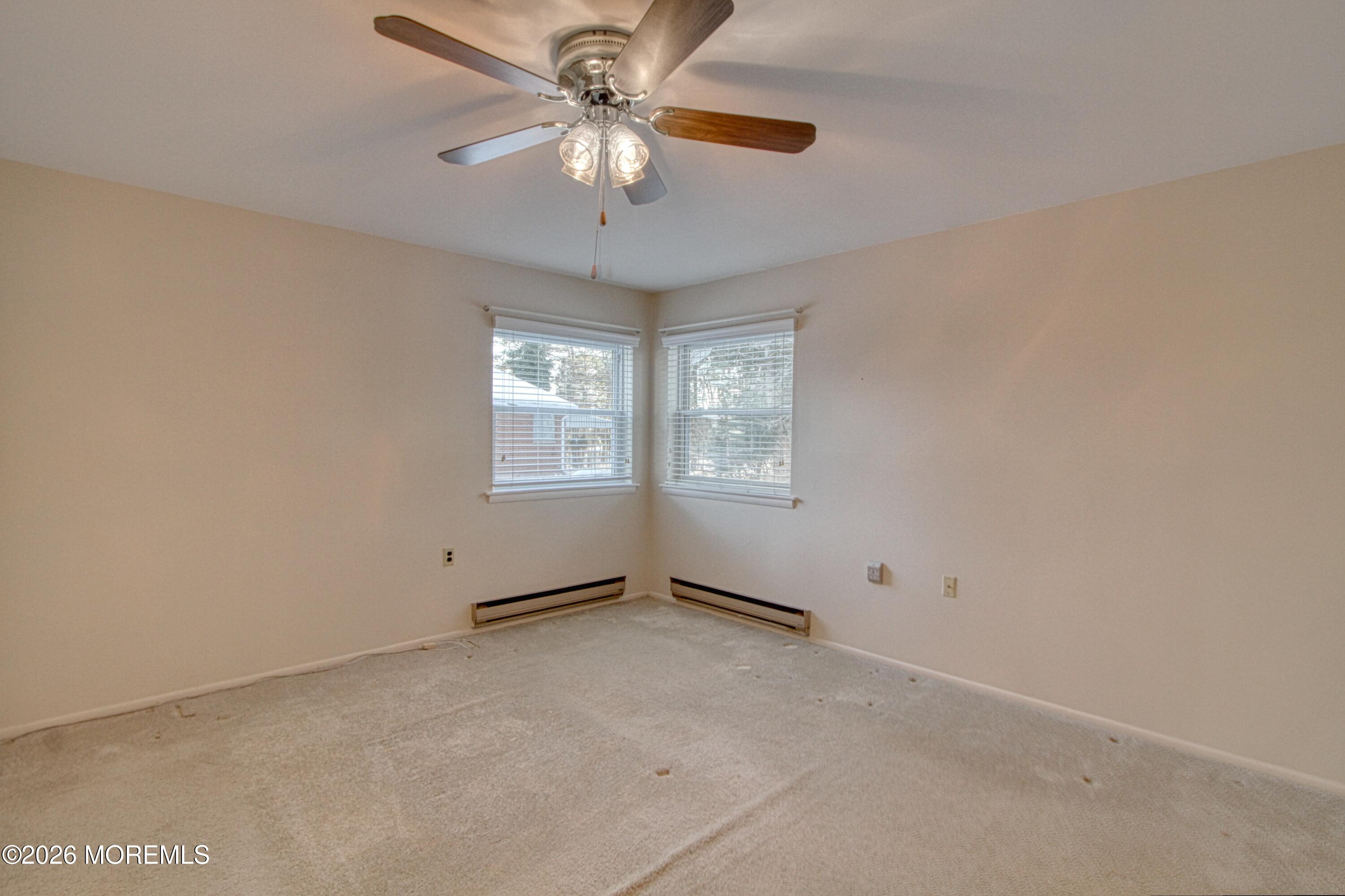 12 Homestead Drive, Unit A Whiting, NJ 08759 - Photo 12 of 18 an empty room with windows and fan