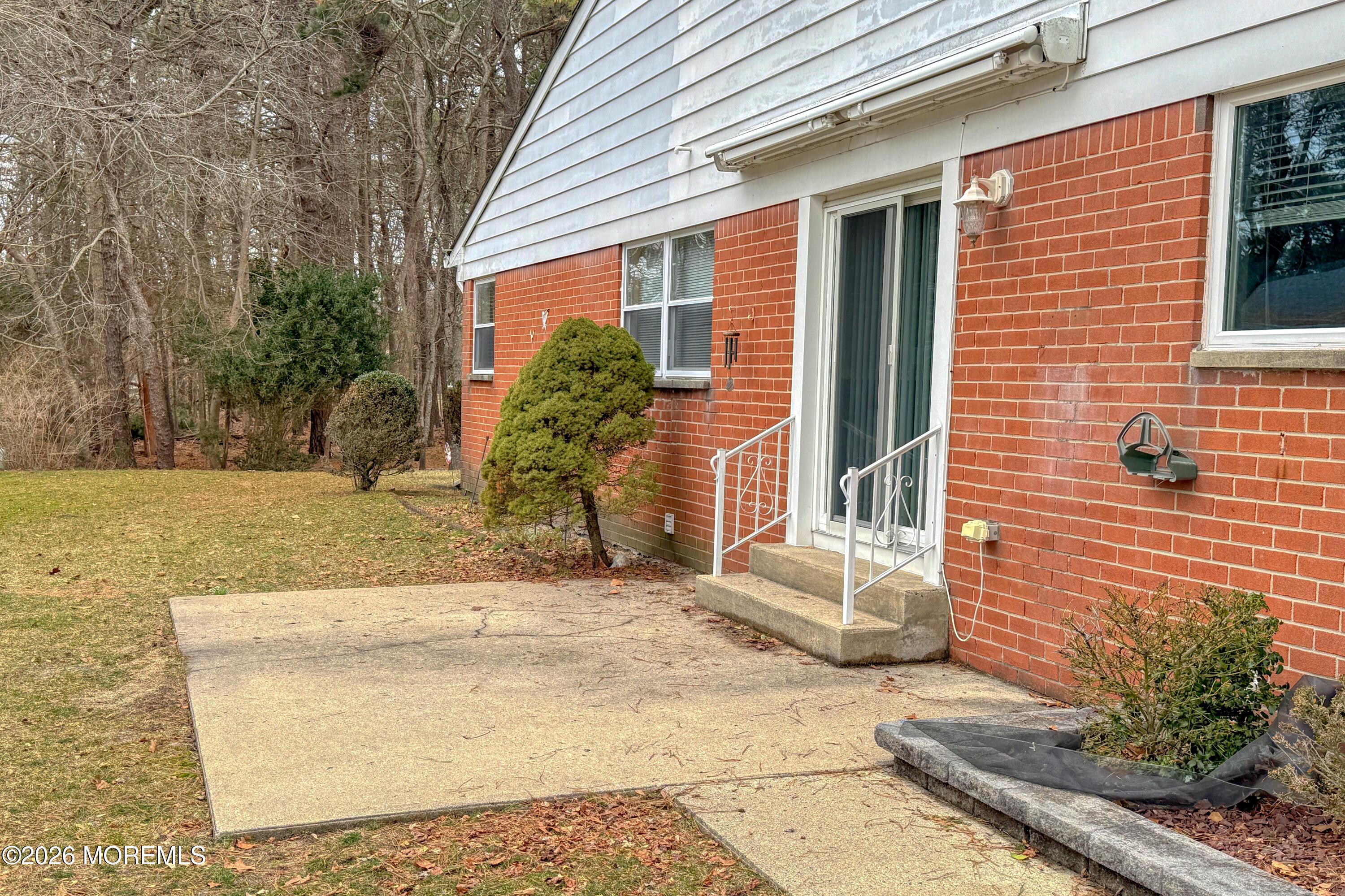 12 Homestead Drive, Unit A Whiting, NJ 08759 - Photo 17 of 18 a view of a brick house with plants