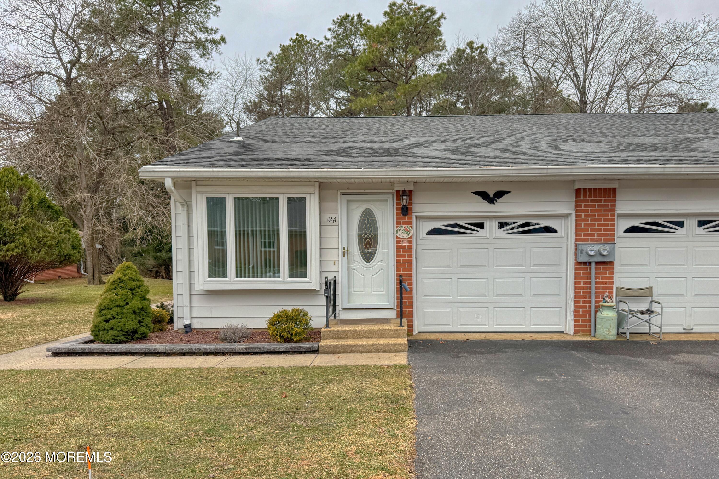12 Homestead Drive, Unit A Whiting, NJ 08759 - Photo 18 of 18 a front view of a house with a yard and garage