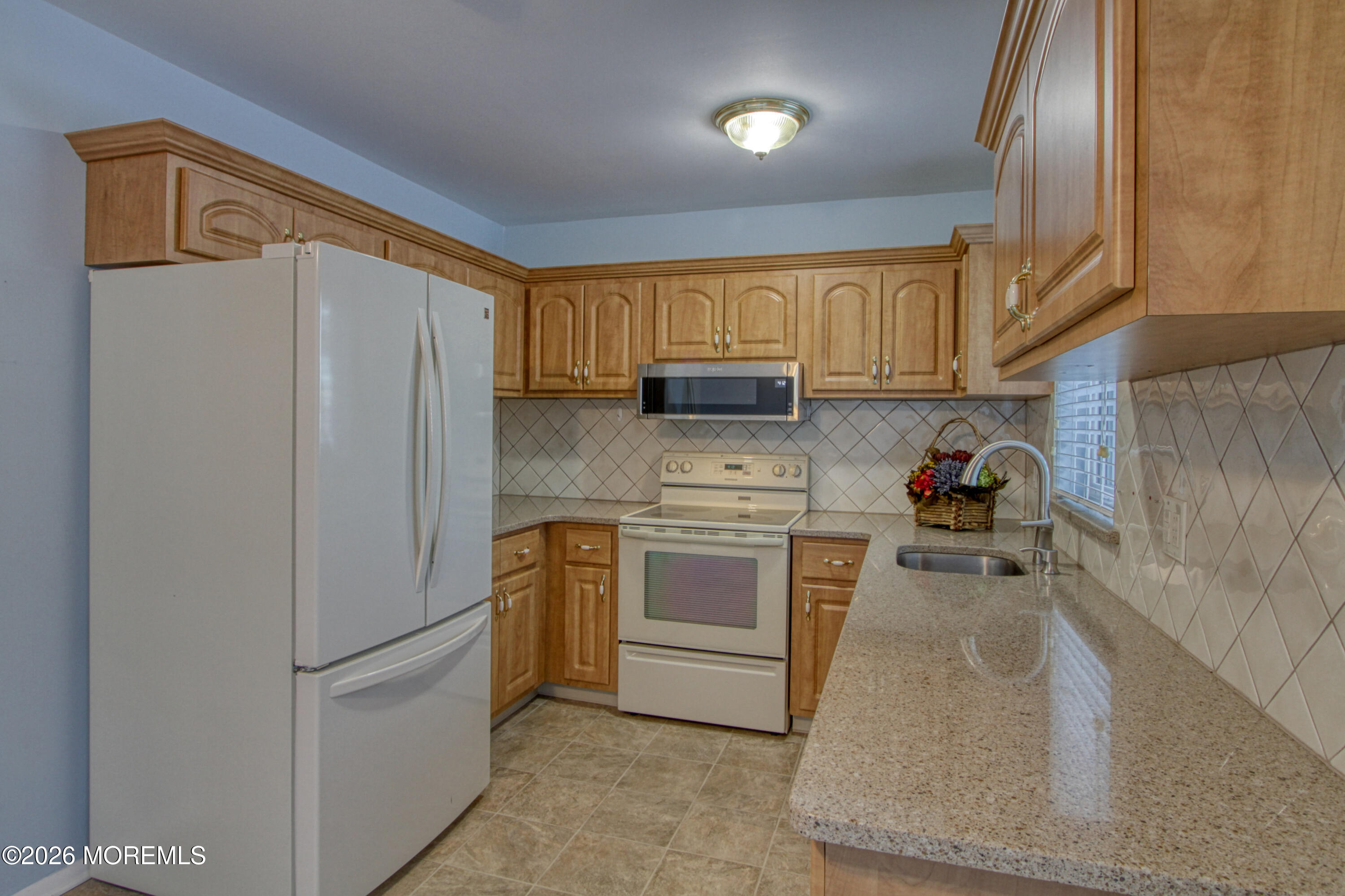 12 Homestead Drive, Unit A Whiting, NJ 08759 - Photo 2 of 18 a kitchen with stainless steel appliances granite countertop a refrigerator sink and stove