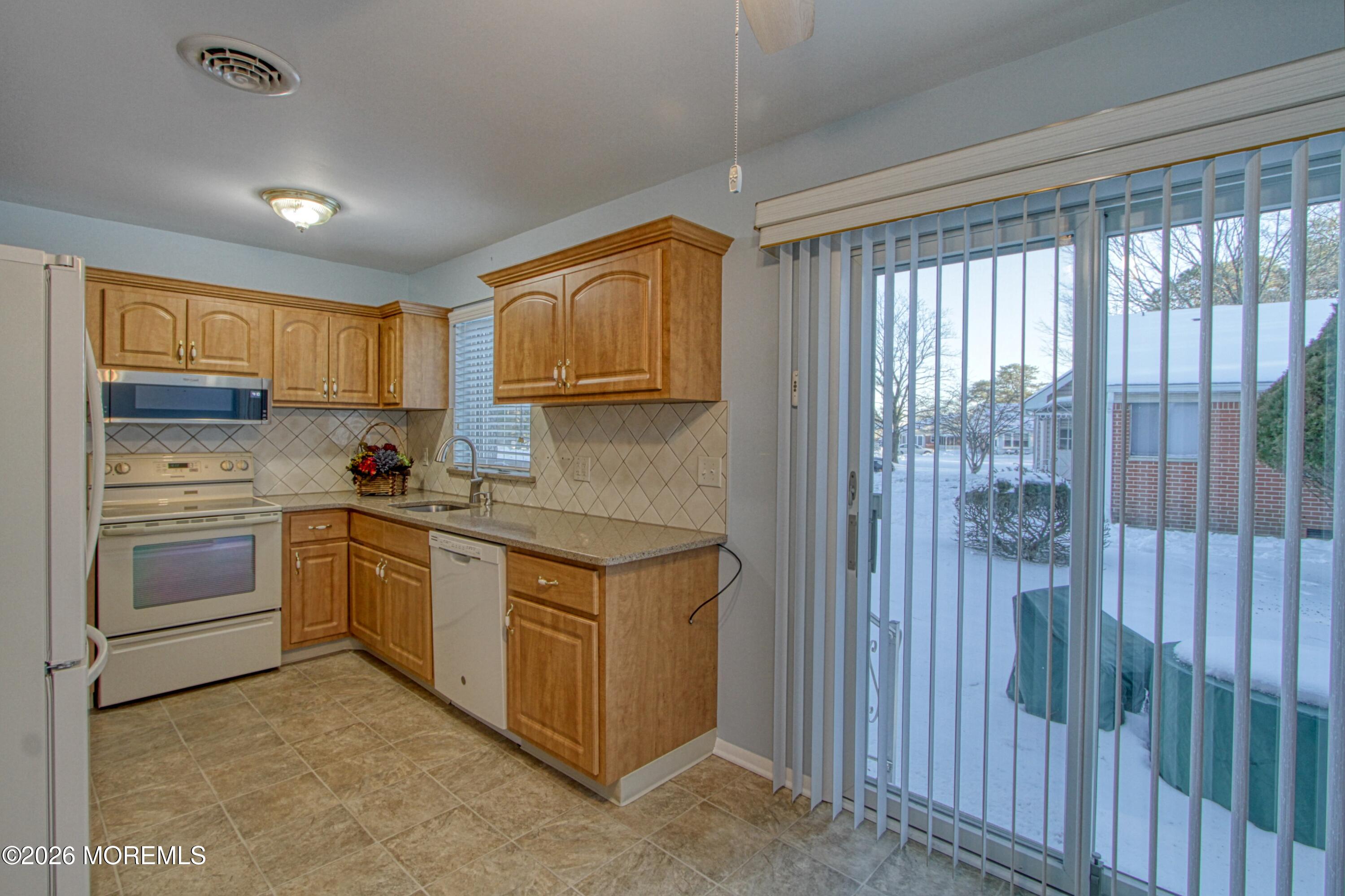 12 Homestead Drive, Unit A Whiting, NJ 08759 - Photo 3 of 18 a kitchen with stainless steel appliances granite countertop a stove a sink and a refrigerator