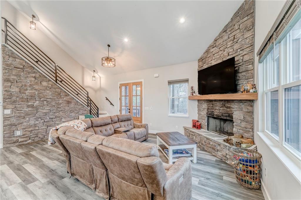 1172 Hunter Drive Ranger, GA 30734 - Photo 18 of 78 a living room with furniture a fireplace and a flat screen tv