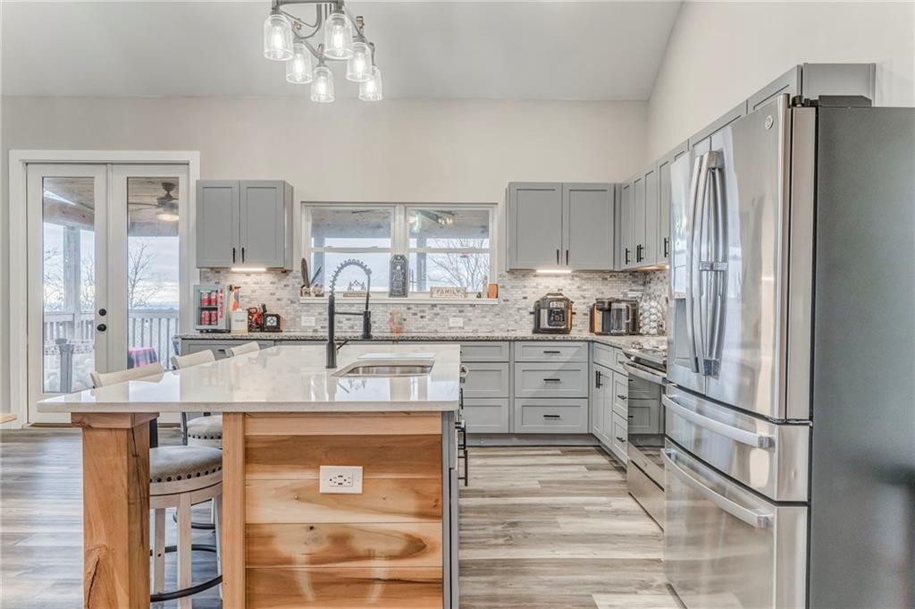1172 Hunter Drive Ranger, GA 30734 - Photo 22 of 78 a kitchen with stainless steel appliances granite countertop a refrigerator and a stove top oven