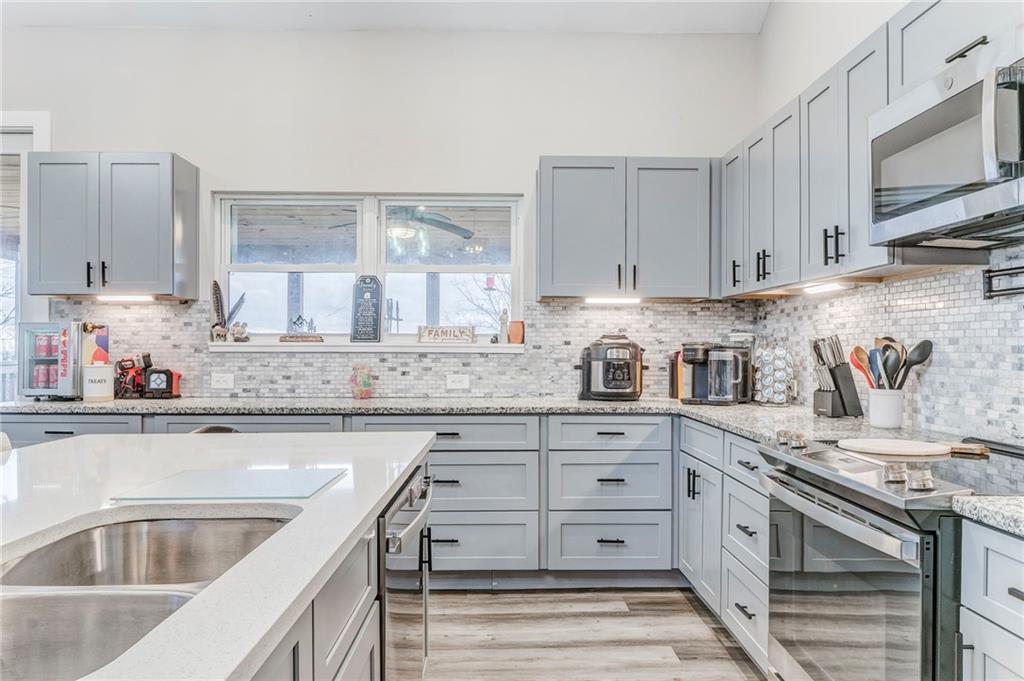 1172 Hunter Drive Ranger, GA 30734 - Photo 23 of 78 a kitchen with granite countertop a sink stainless steel appliances and cabinets