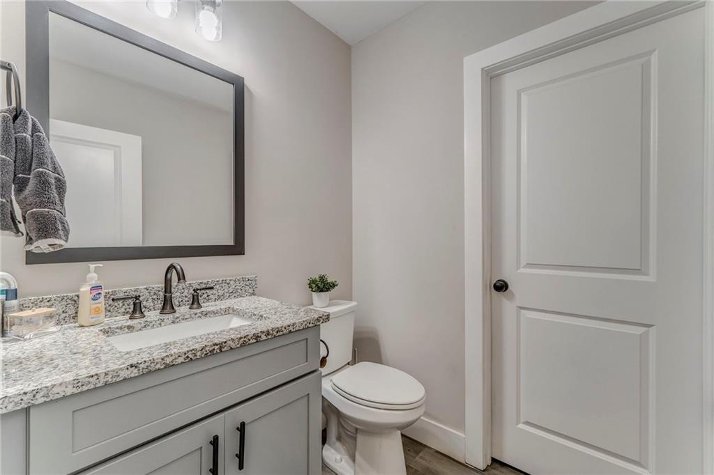 1172 Hunter Drive Ranger, GA 30734 - Photo 31 of 78 a bathroom with a granite countertop toilet sink and mirror