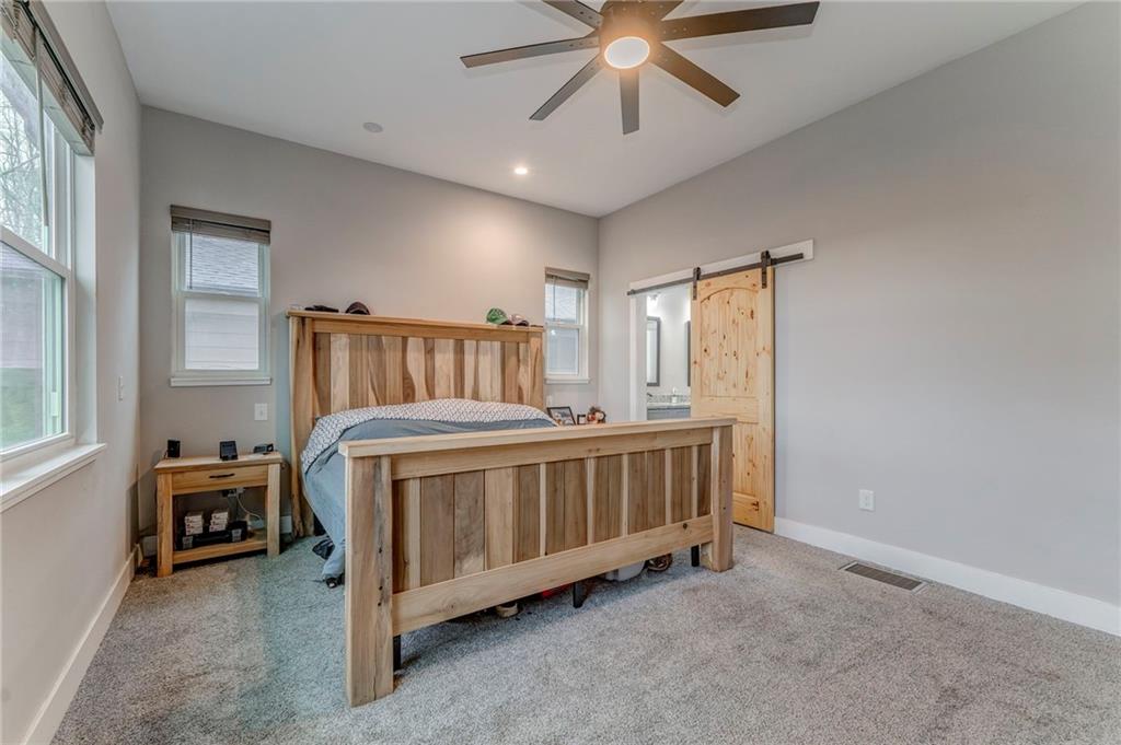 1172 Hunter Drive Ranger, GA 30734 - Photo 36 of 78 a bedroom with a bed and a chandelier