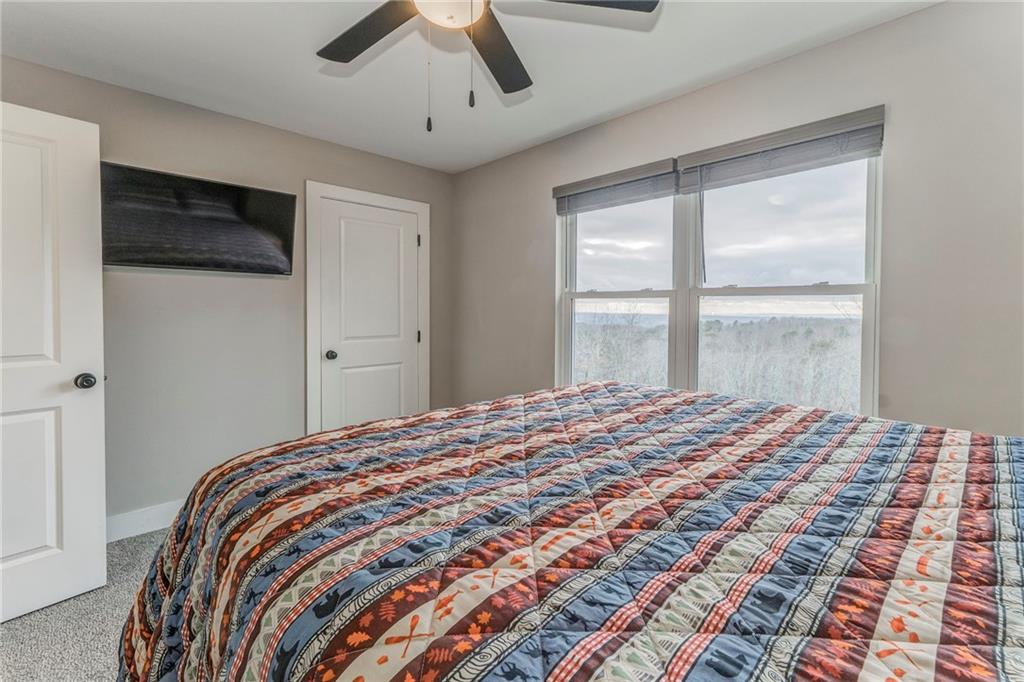 1172 Hunter Drive Ranger, GA 30734 - Photo 52 of 78 a bedroom with a large bed and a window