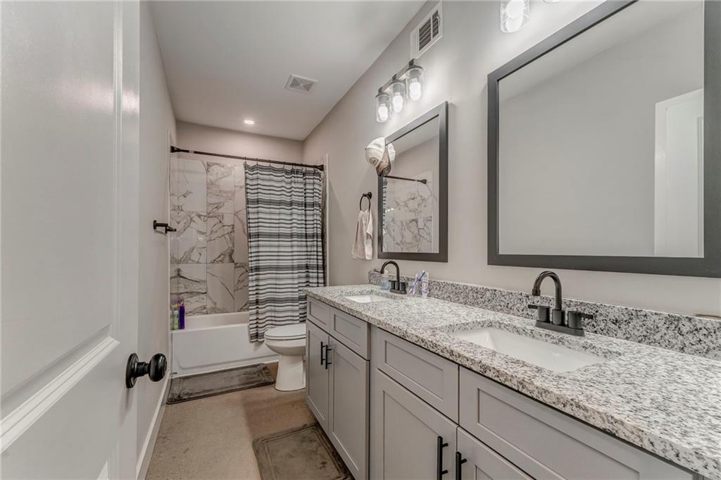 1172 Hunter Drive Ranger, GA 30734 - Photo 60 of 78 a bathroom with a granite countertop sink mirror and a bathtub