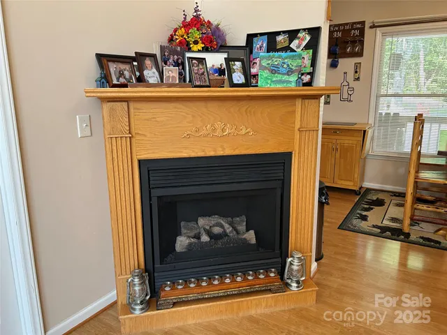 a living room with furniture a fireplace and next to a window