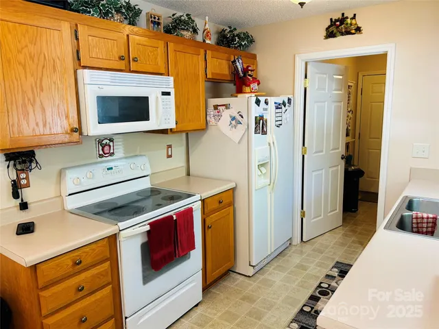 a kitchen with a sink stove and refrigerator