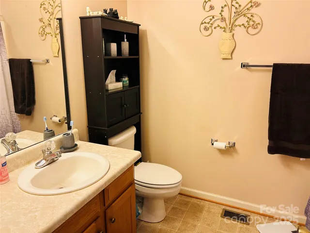 a bathroom with a toilet and a shower curtain