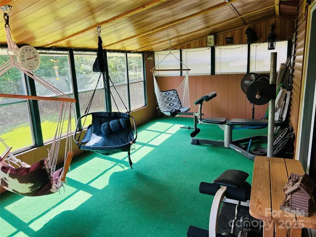 a view of balcony with wooden floor and seating space