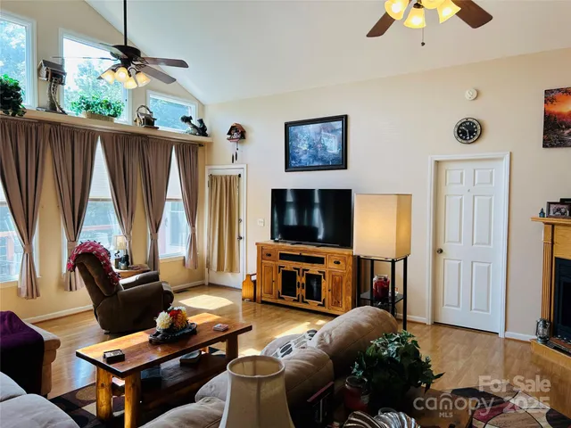 a living room with furniture a flat screen tv and a window