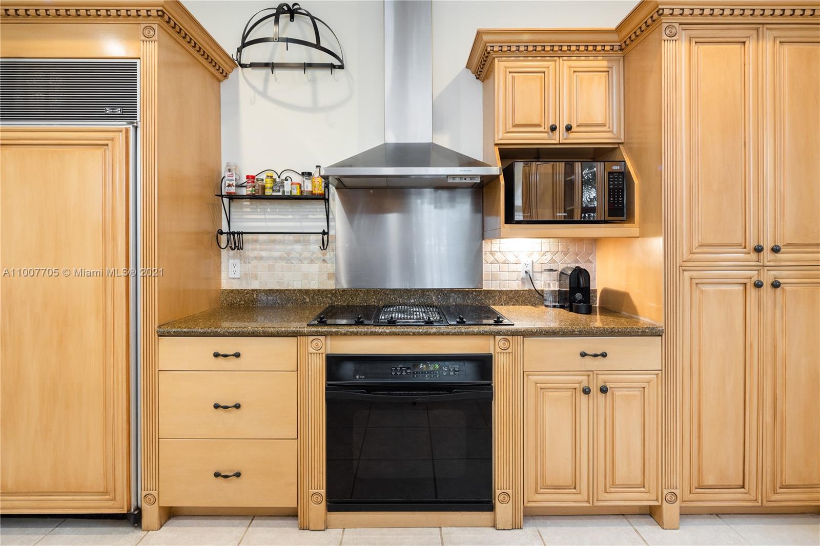 1385 North Biscayne Point Road Miami Beach, FL 33141 - Photo 11 of 68 a kitchen with stainless steel appliances granite countertop a stove and a microwave