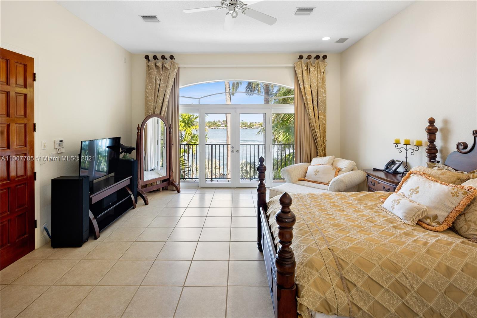 1385 North Biscayne Point Road Miami Beach, FL 33141 - Photo 27 of 68 a bedroom with a bed and a chandelier
