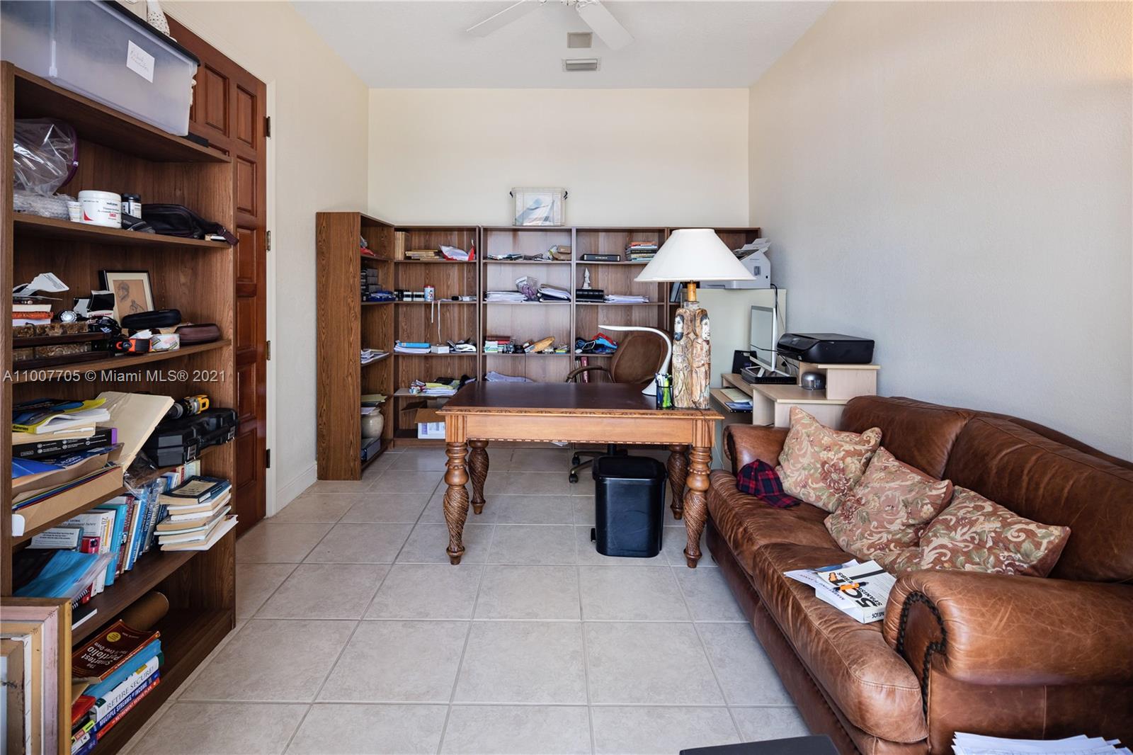 1385 North Biscayne Point Road Miami Beach, FL 33141 - Photo 47 of 68 a living room with furniture and a bookshelf