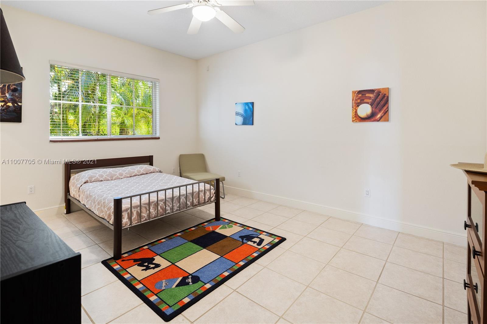 1385 North Biscayne Point Road Miami Beach, FL 33141 - Photo 48 of 68 a bedroom with a bed and a window