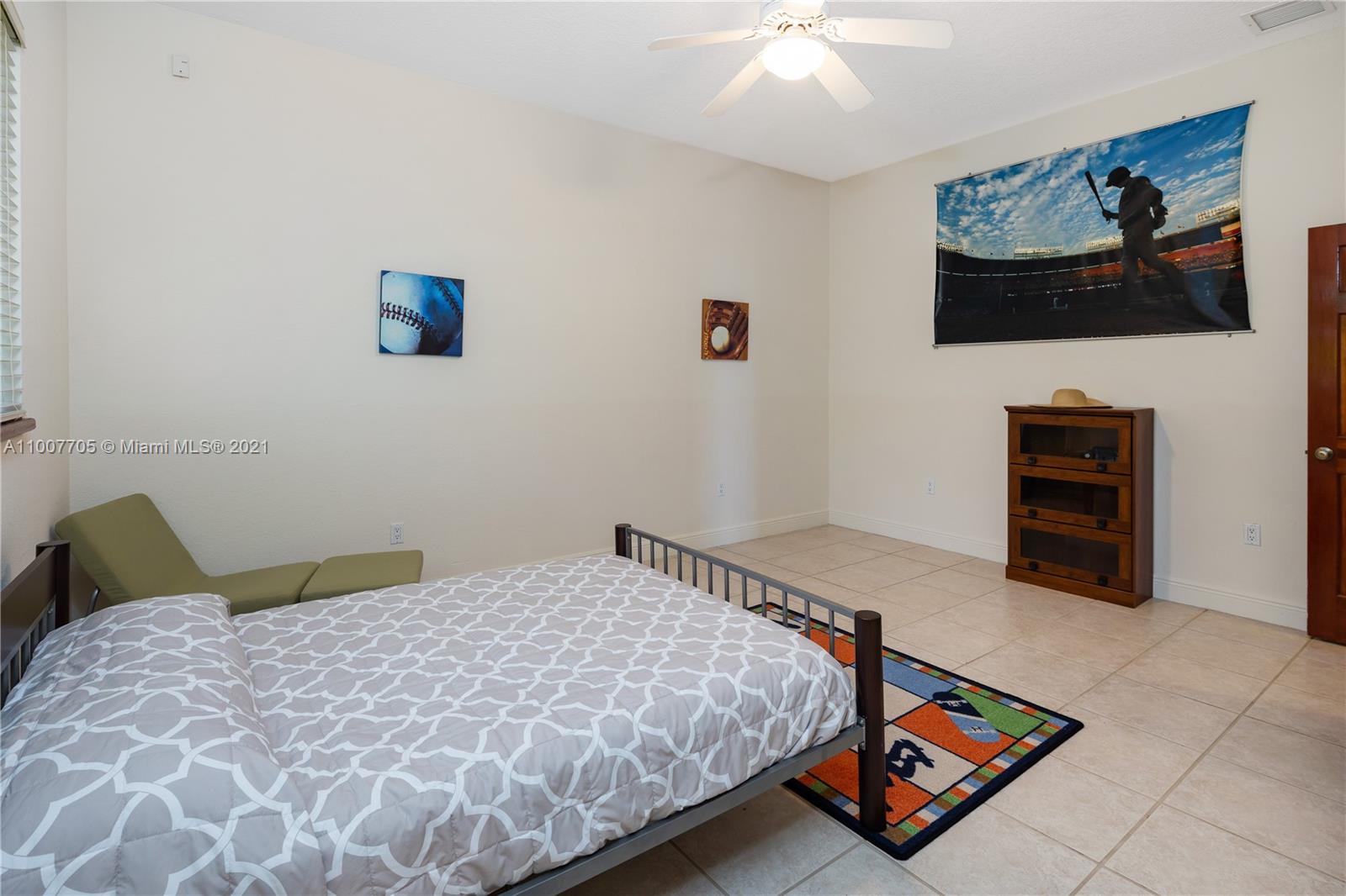 1385 North Biscayne Point Road Miami Beach, FL 33141 - Photo 49 of 68 a bedroom with a bed and a chandelier