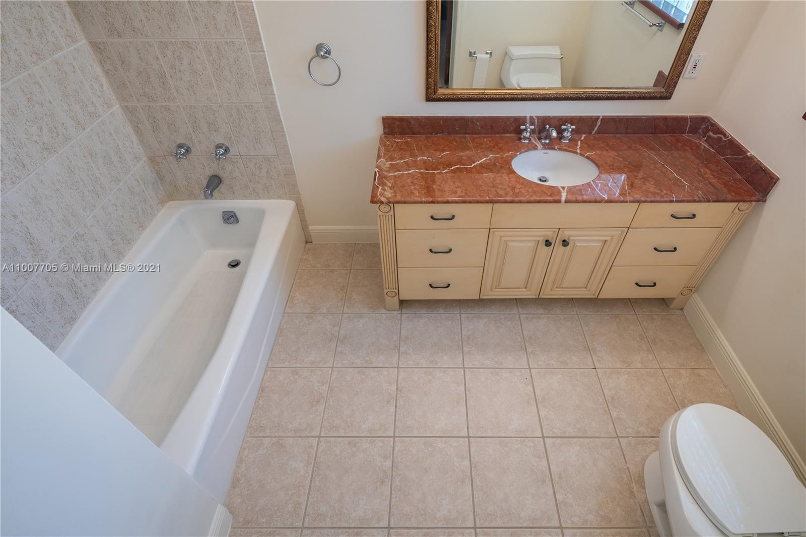 1385 North Biscayne Point Road Miami Beach, FL 33141 - Photo 52 of 68 a bathroom with a sink vanity granite tub toilet and mirror