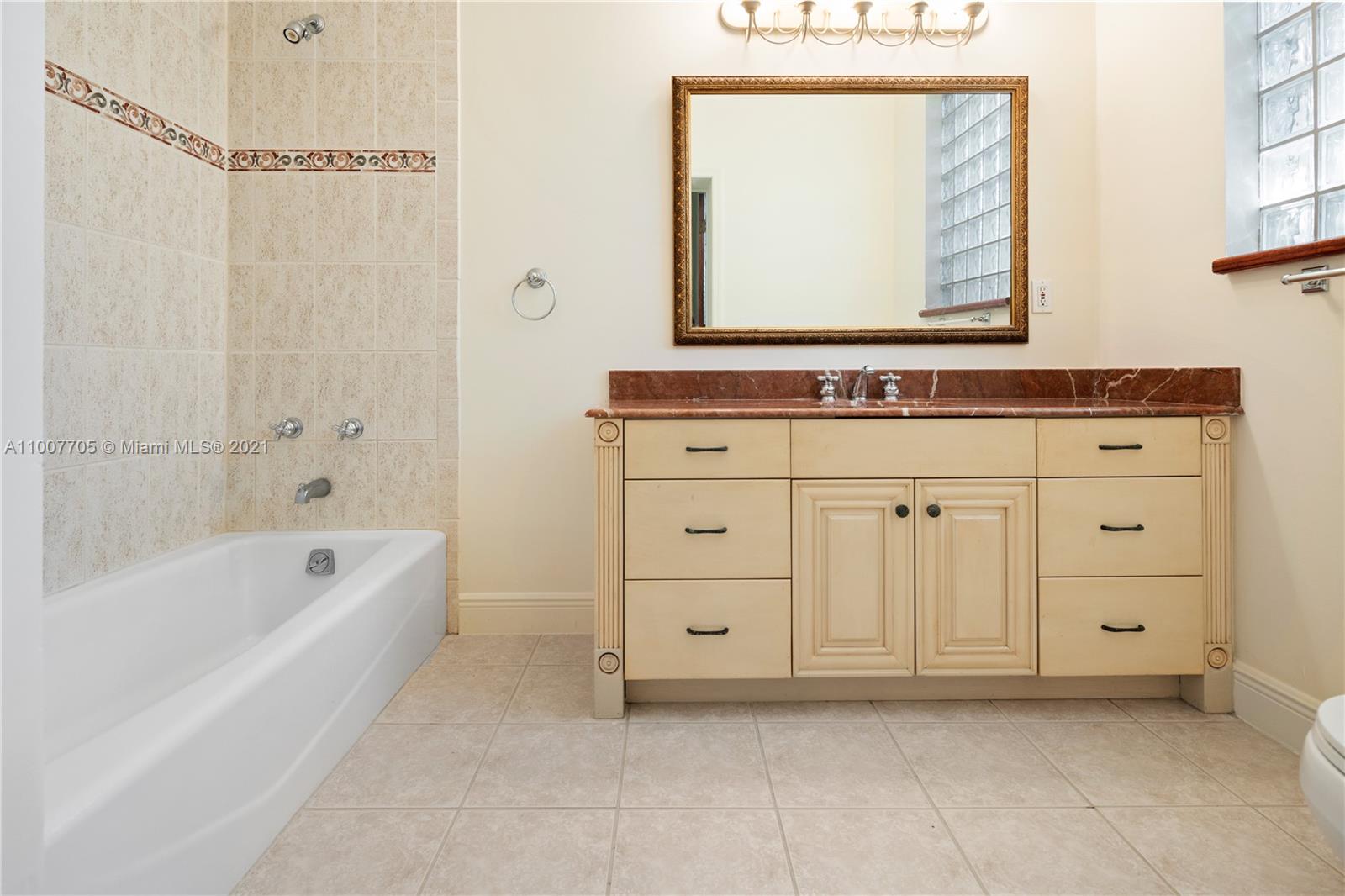 1385 North Biscayne Point Road Miami Beach, FL 33141 - Photo 53 of 68 a bathroom with a bathtub sink and a mirror