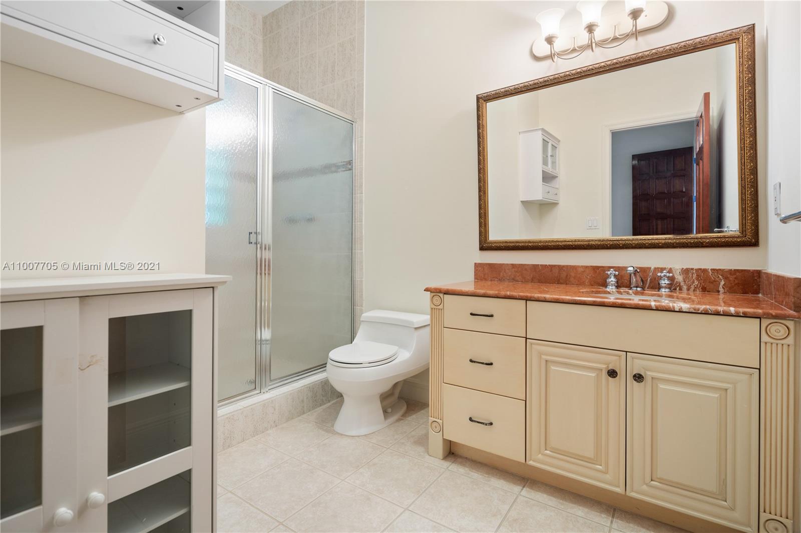 1385 North Biscayne Point Road Miami Beach, FL 33141 - Photo 56 of 68 a bathroom with a toilet a sink a vanity and mirror