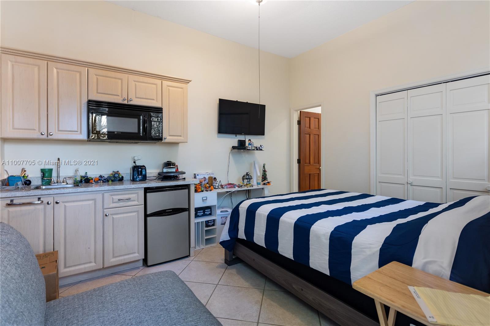 1385 North Biscayne Point Road Miami Beach, FL 33141 - Photo 57 of 68 a bedroom with a bed and a flat screen tv