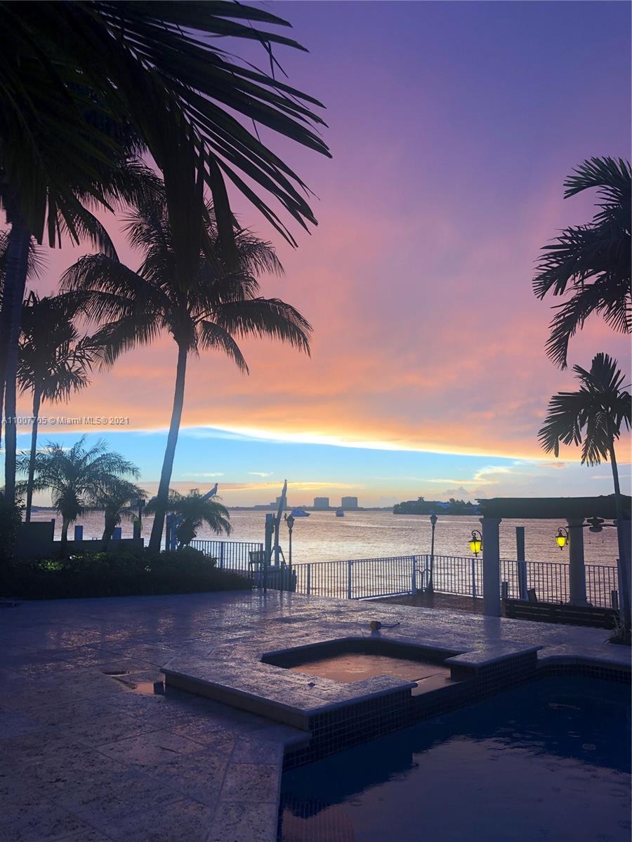 1385 North Biscayne Point Road Miami Beach, FL 33141 - Photo 64 of 68 a view of swimming pool with a table and chairs under an umbrella