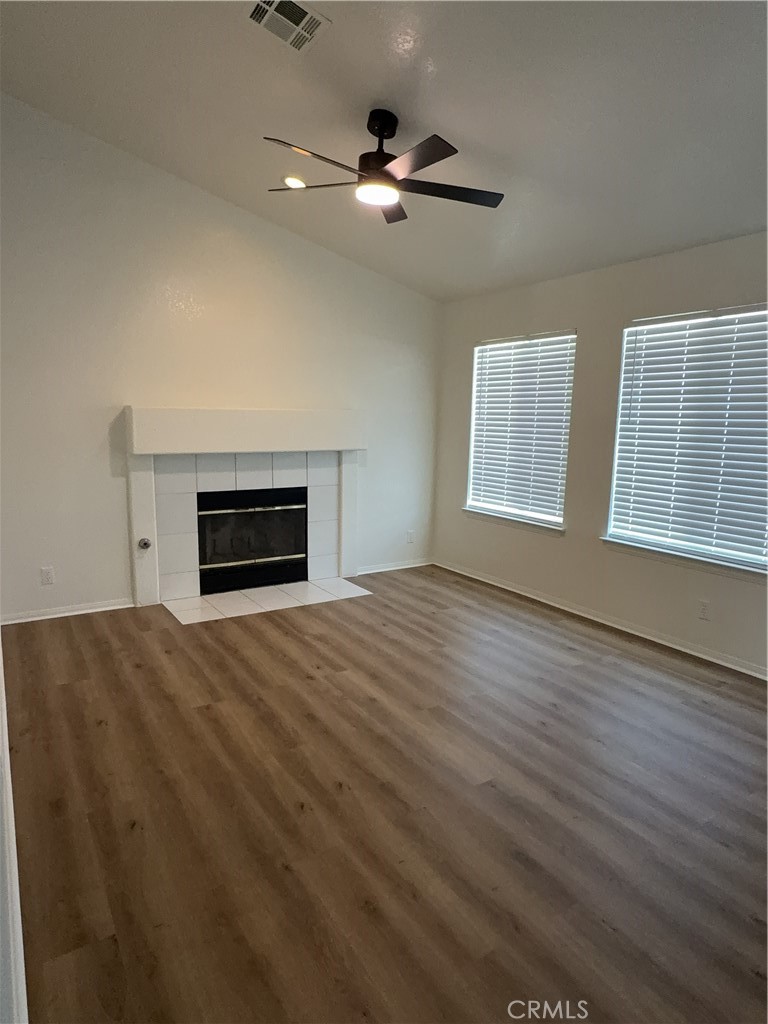 12590 Cobalt Road Victorville, CA 92392 - Photo 15 of 37 a view of empty room with wooden floor and fireplace