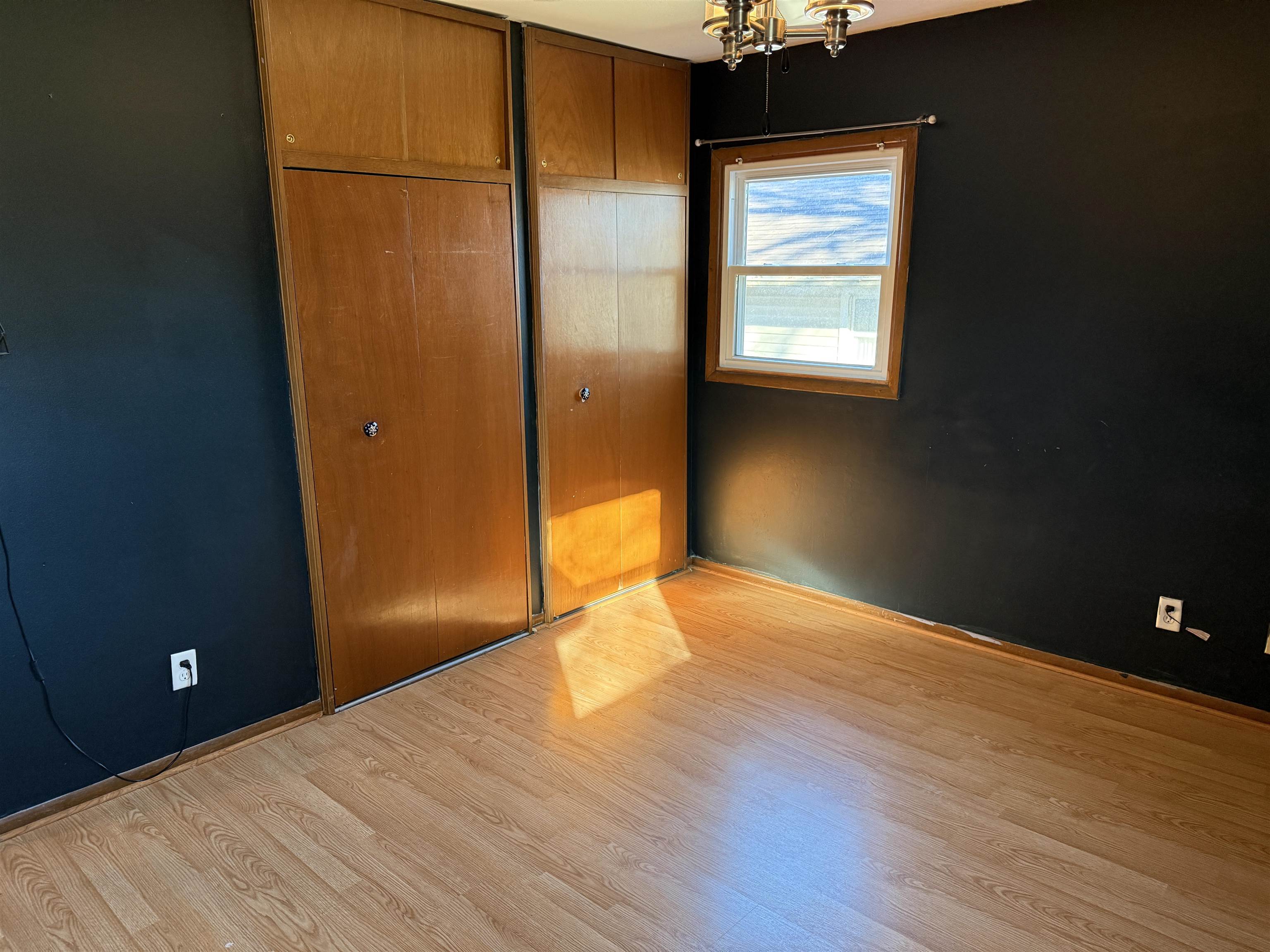 3237 West Carthage Drive Freeport, IL 61032 - Photo 7 of 14 a view of an empty room with wooden floor and a window