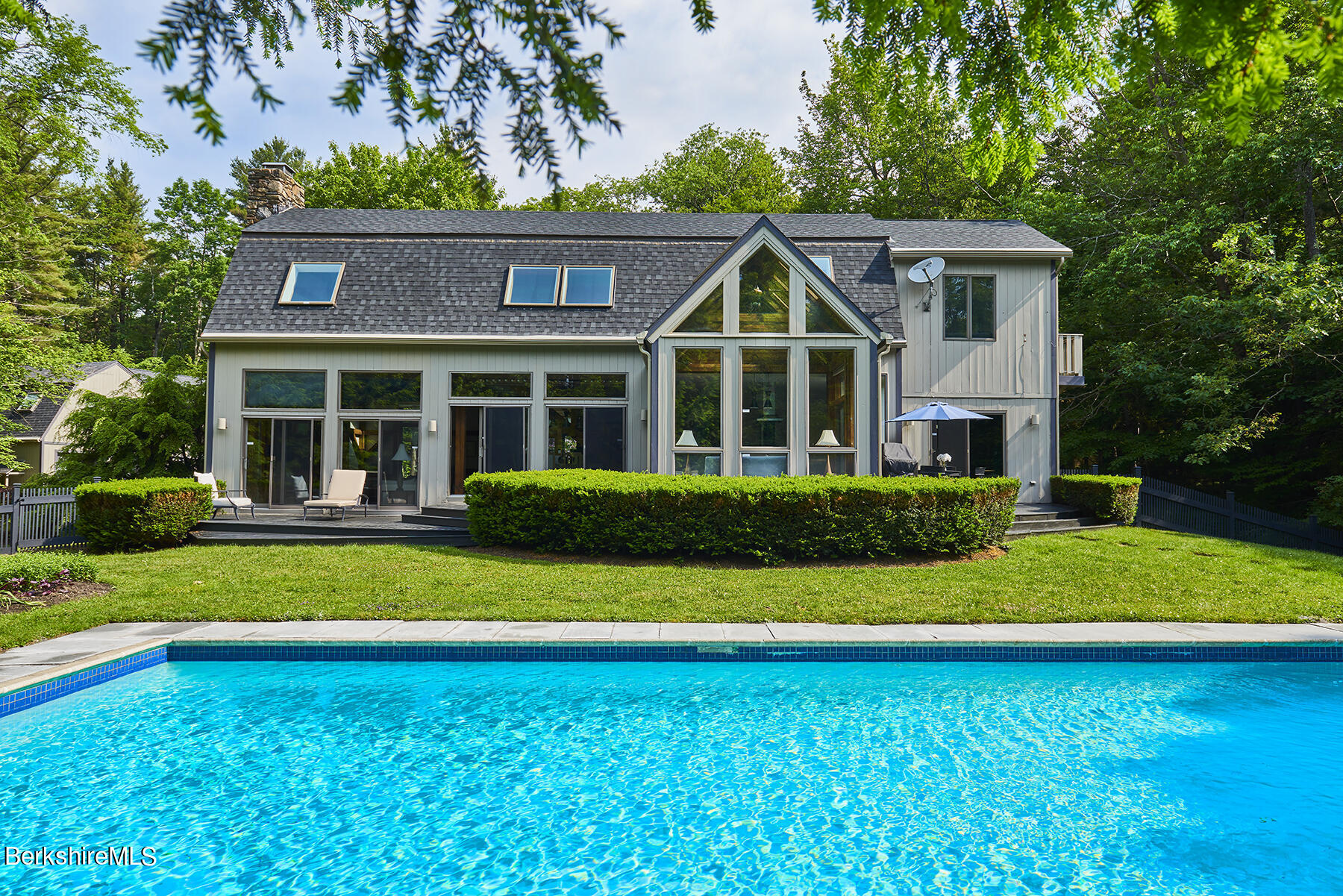 130 Woodmere Road Becket, MA 01223 - Photo 1 of 50 a front view of a house with a yard and trees