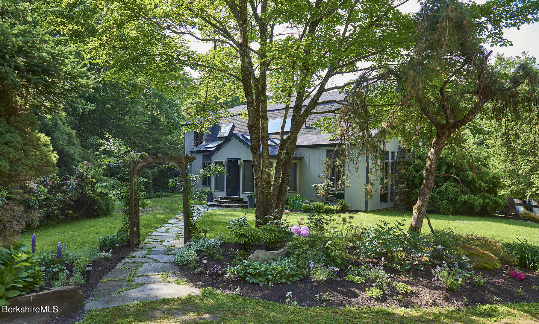 130 Woodmere Road Becket, MA 01223 - Photo 3 of 50 a front view of a house with a yard and green space