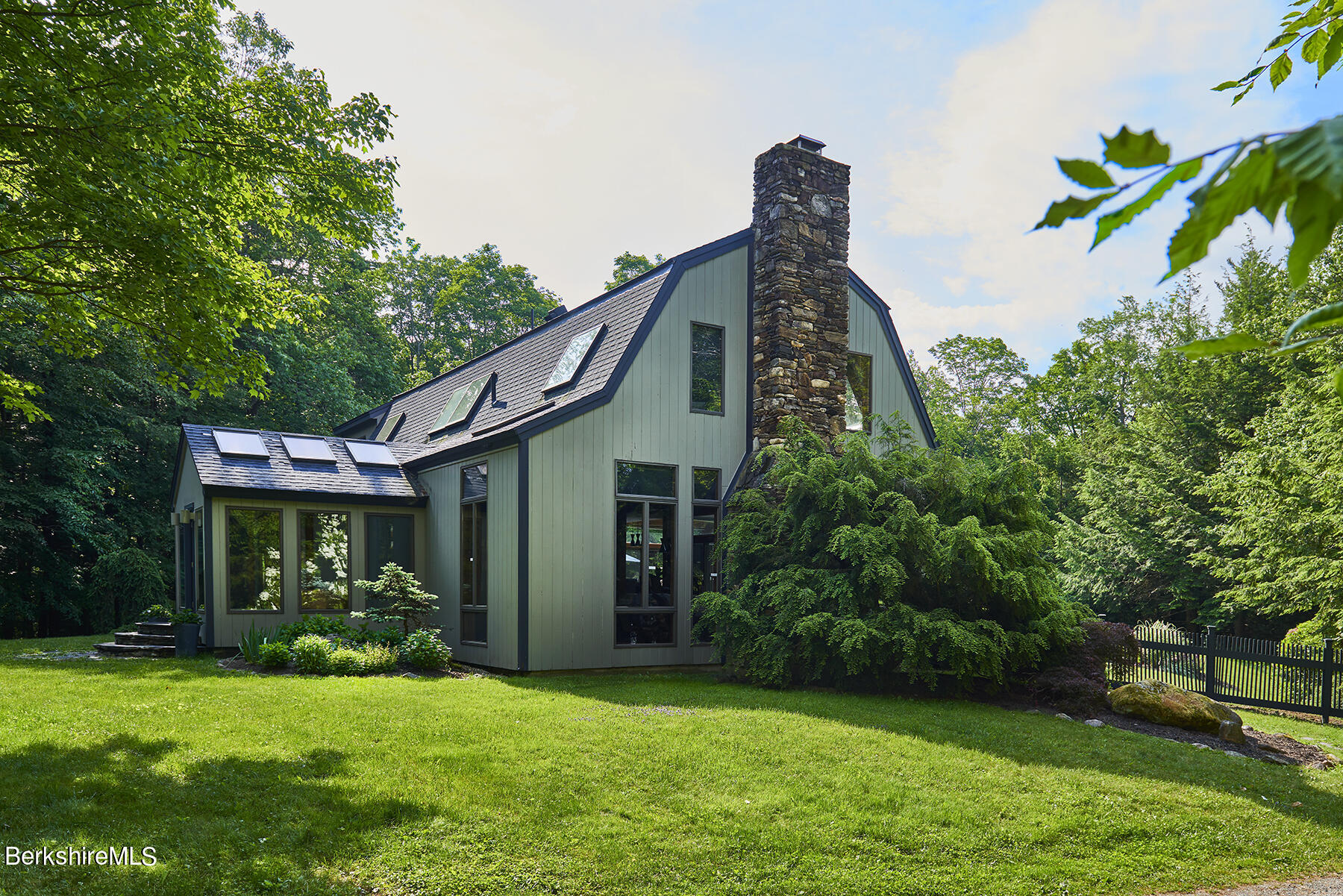 130 Woodmere Road Becket, MA 01223 - Photo 31 of 50 a front view of a house with a garden