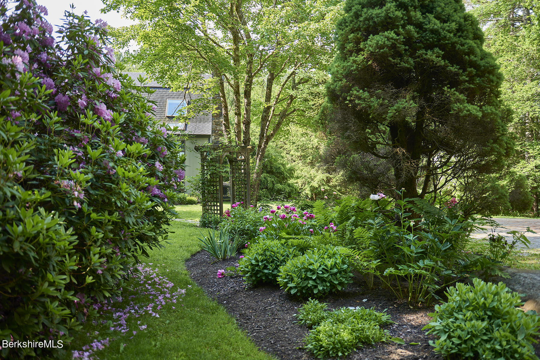 130 Woodmere Road Becket, MA 01223 - Photo 33 of 50 a view of a garden with plants and large trees