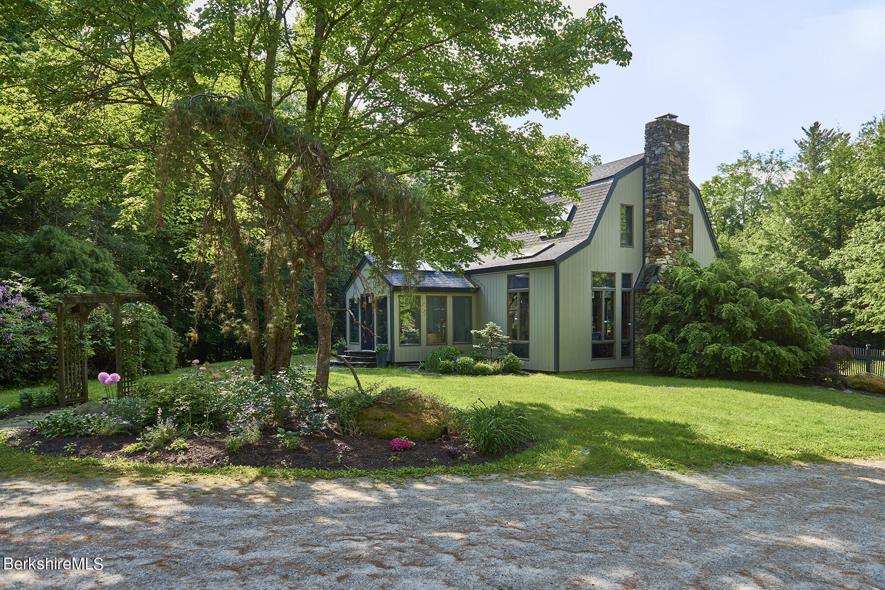 130 Woodmere Road Becket, MA 01223 - Photo 34 of 50 a front view of a house with garden