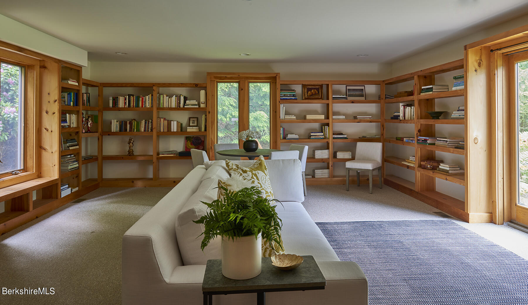 130 Woodmere Road Becket, MA 01223 - Photo 38 of 50 a living room with furniture floor to ceiling window and potted plant