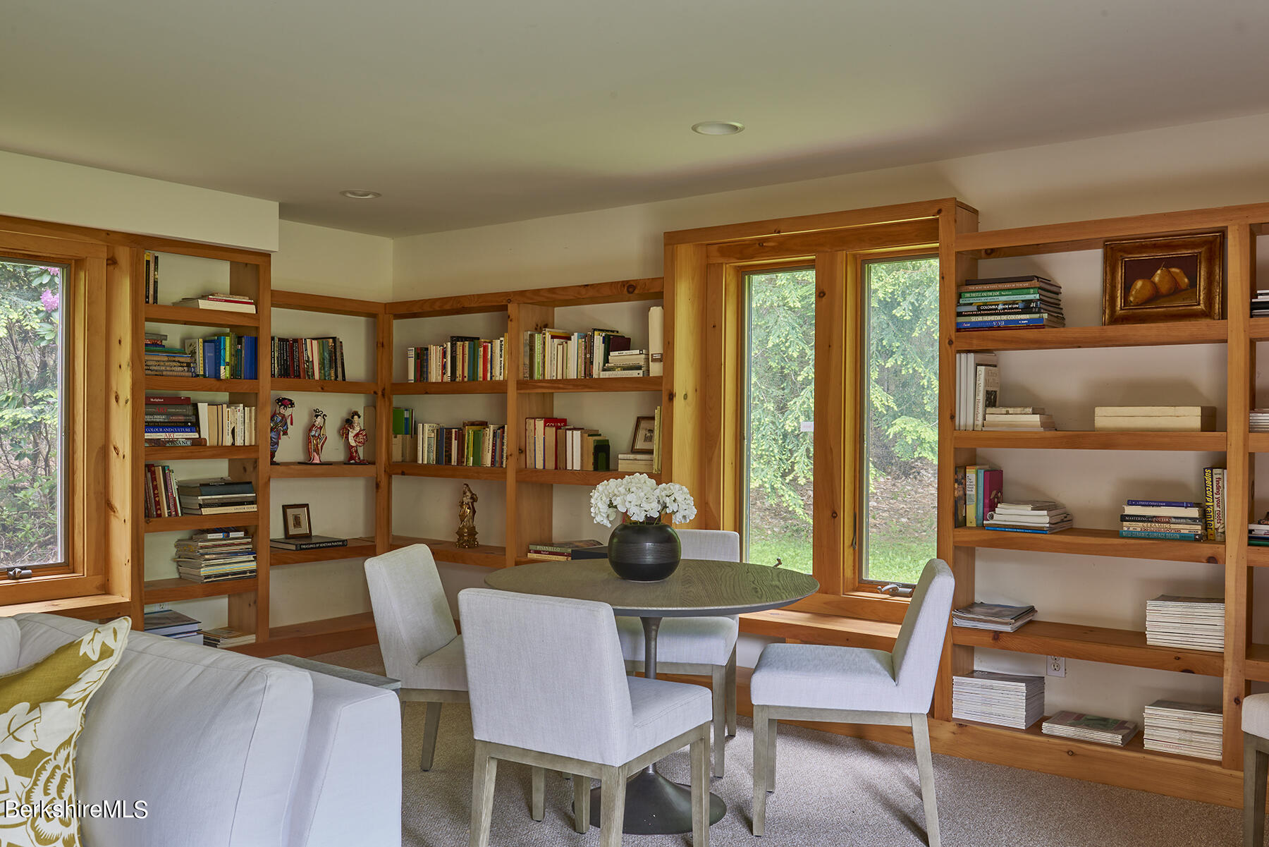 130 Woodmere Road Becket, MA 01223 - Photo 39 of 50 a dining room with furniture and a book shelf