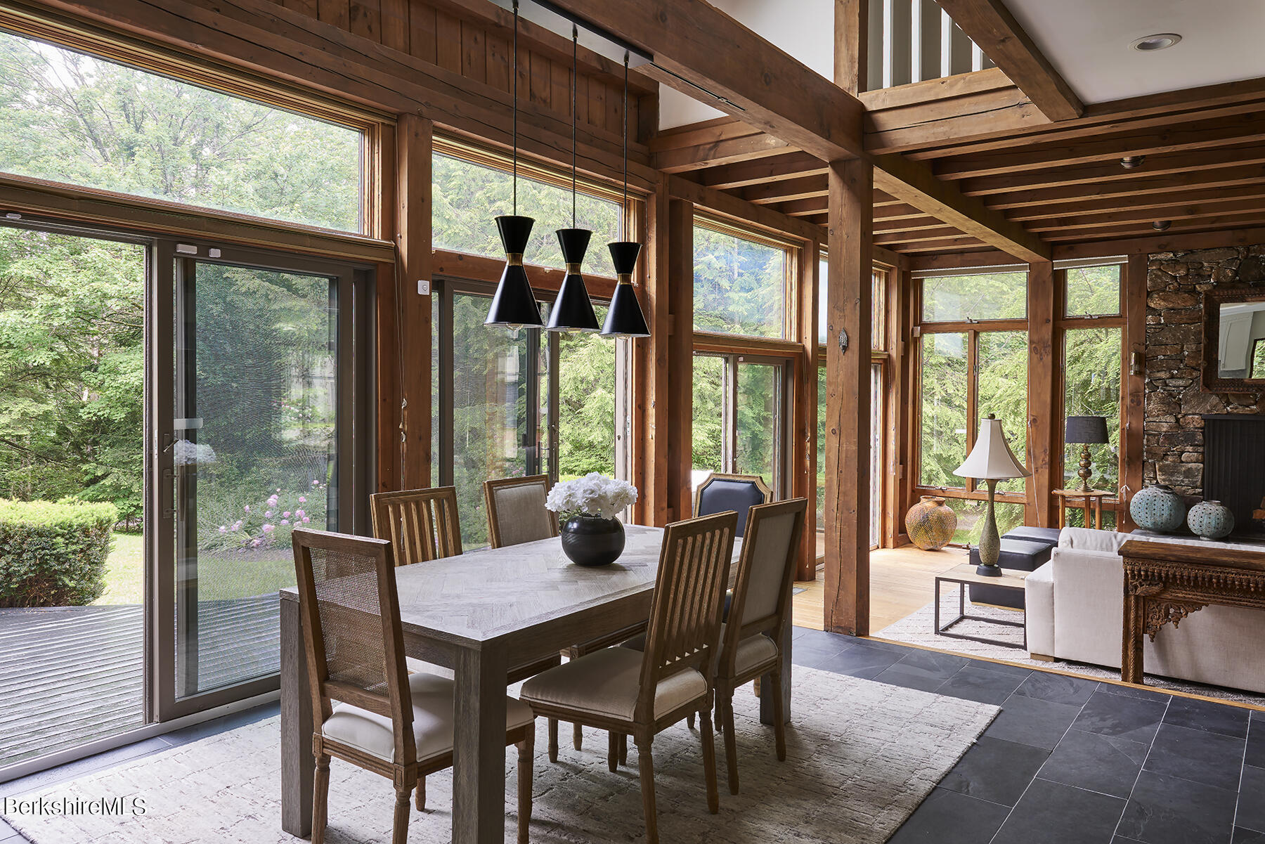 130 Woodmere Road Becket, MA 01223 - Photo 9 of 50 a view of a dining room with furniture large windows and wooden floor