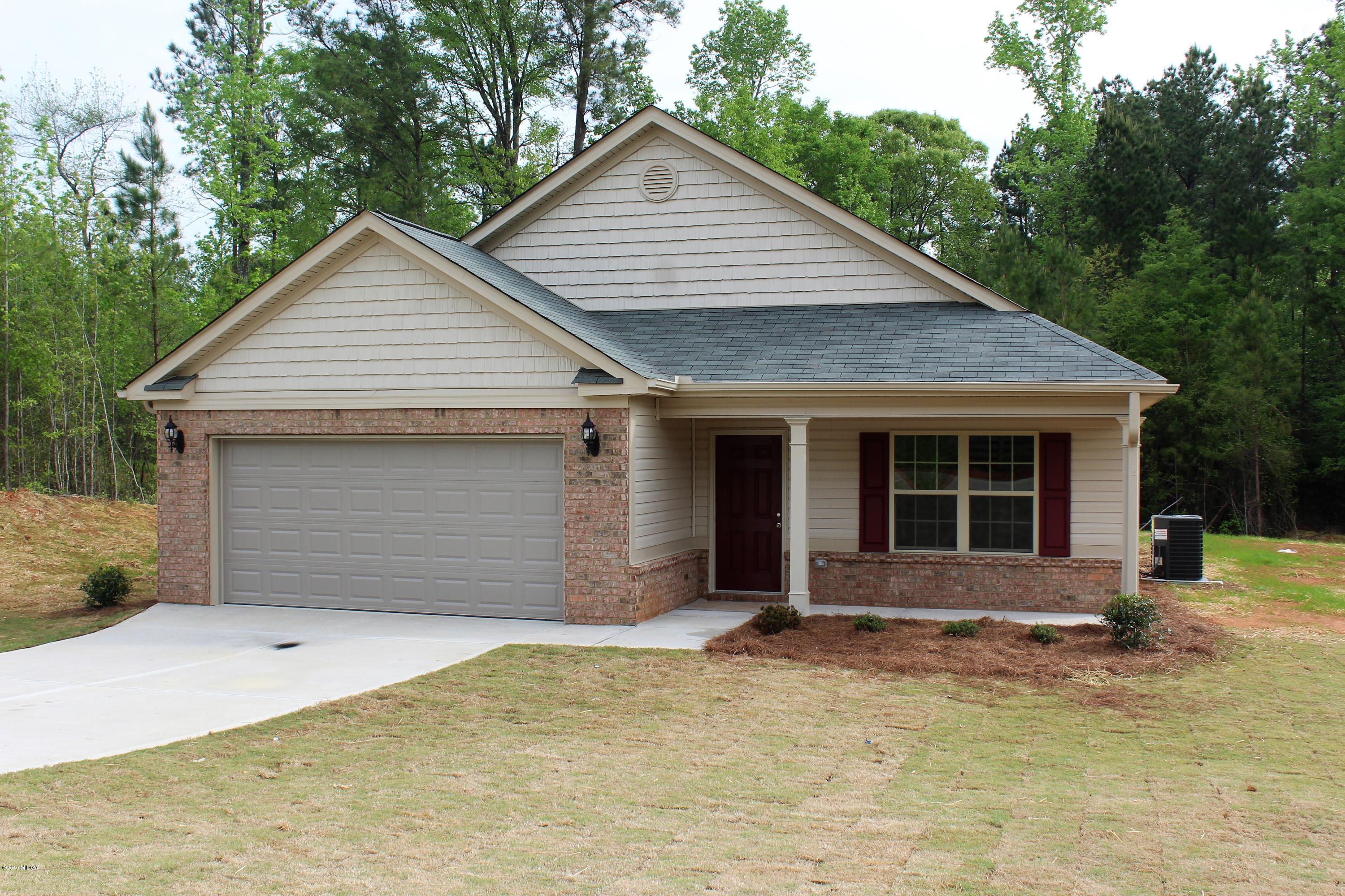805 Weldon Road Forsyth, GA 31029 - Photo 1 of 5 a front view of a house with yard and trees in the background