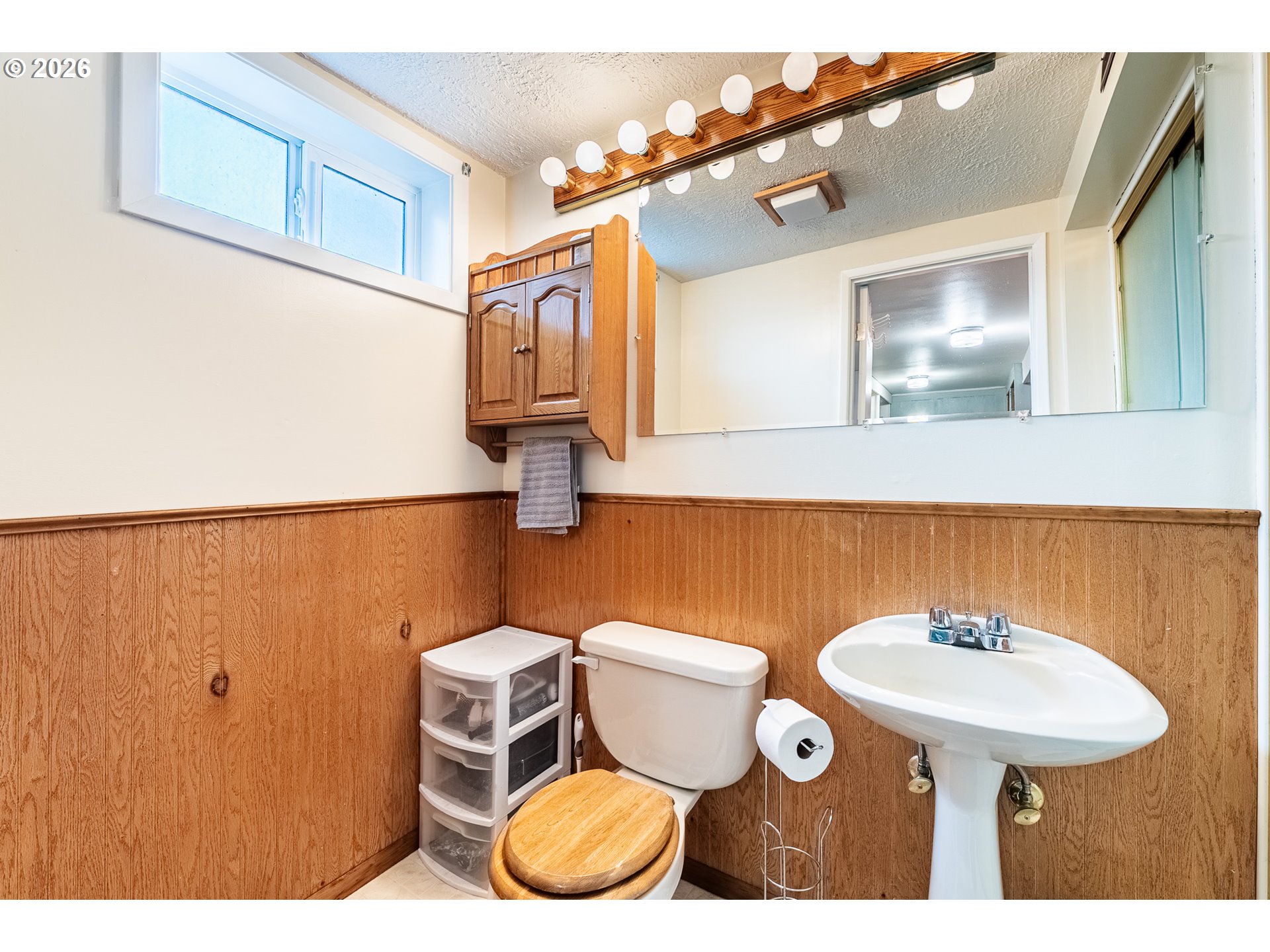 3312 Southwest Kirk Avenue Pendleton, OR 97801 - Photo 16 of 21 a bathroom with a toilet sink and mirror