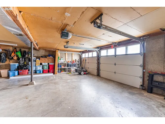 a balcony with wooden floor table and chairs