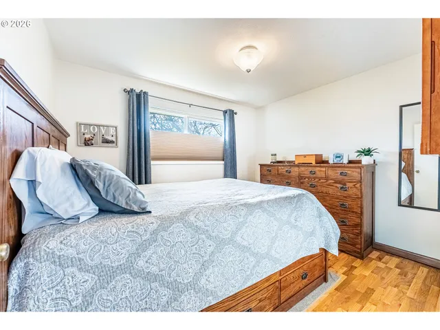 a bed sitting in a bedroom and a night stand