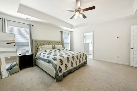 a bedroom with a bed rug and window