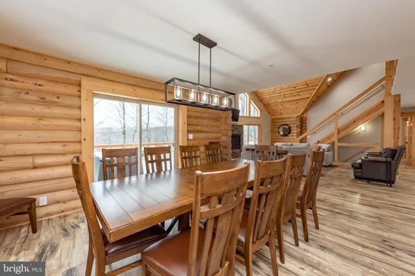a dining room with furniture window and wooden floor