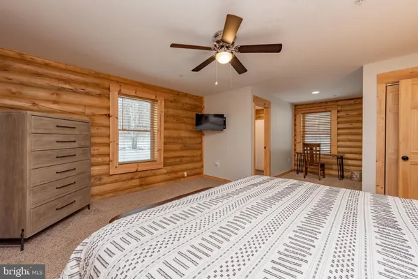 a bedroom with a large bed and a window