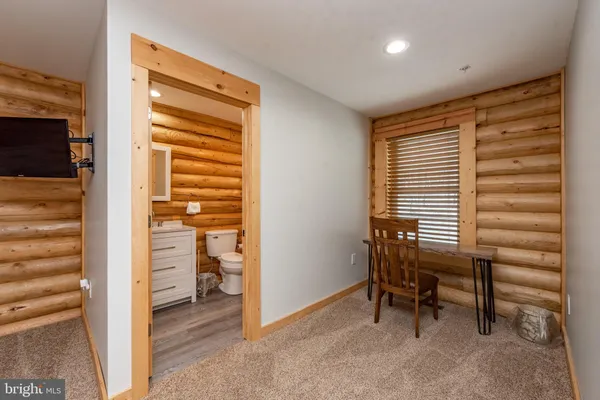 a bathroom with a sink a toilet a mirror and shower