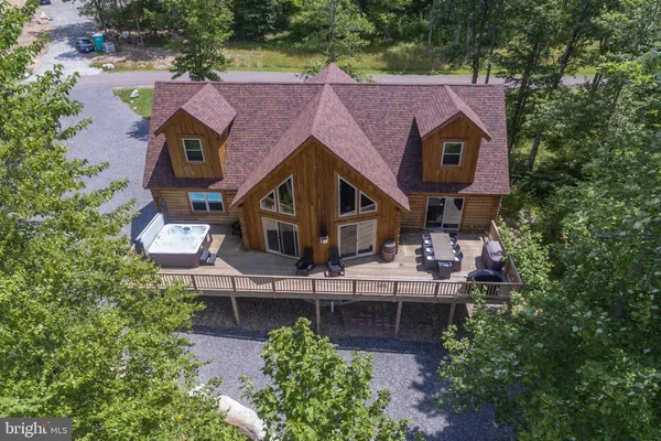 an aerial view of a house with swimming pool and garden
