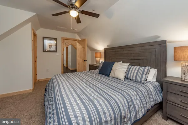 a living room with furniture a ceiling fan and a rug